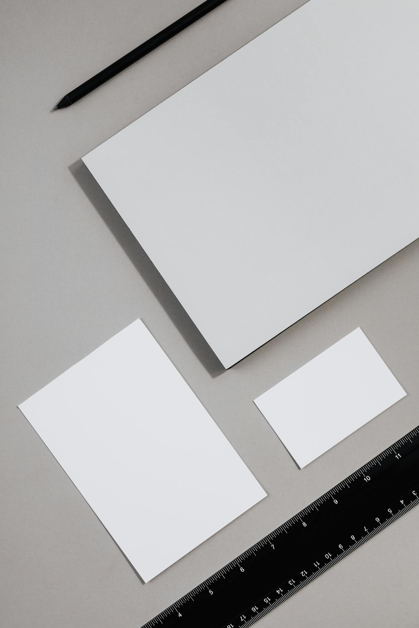 Top view of blank stationery items on a neutral background, perfect for design mockups.